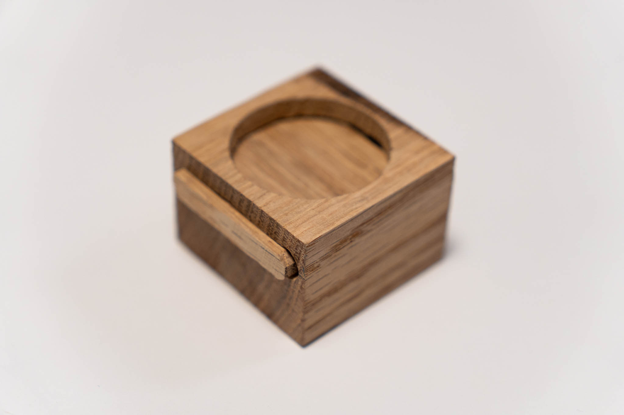 a small rectangular wooden light-brown box with its lid fully inserted